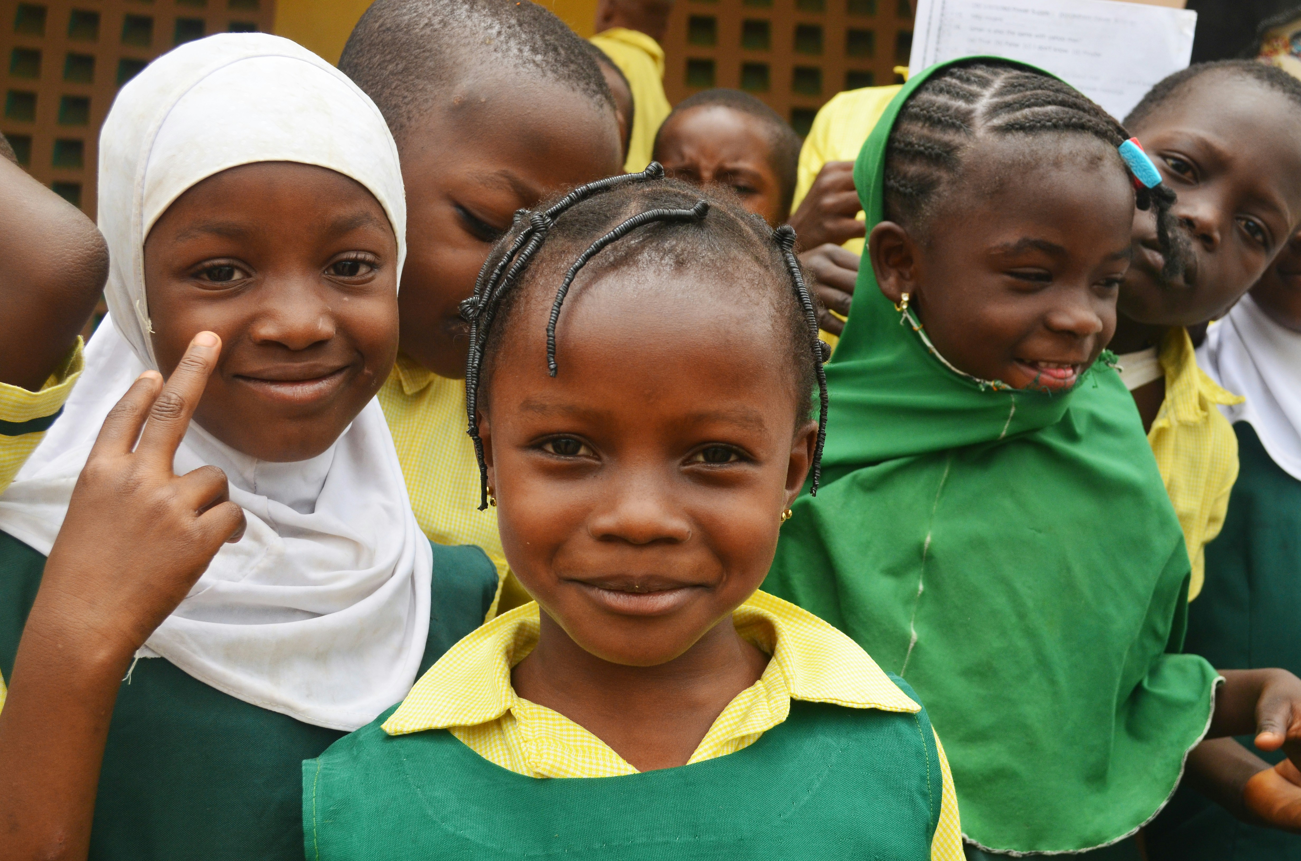 Children in green and yellow uniforms.